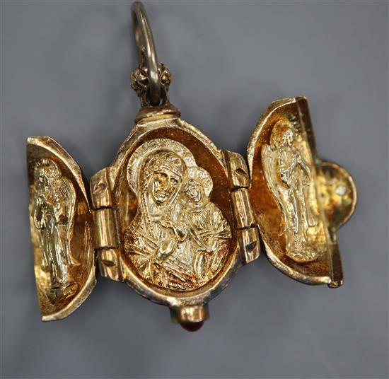 A gilt white metal and enamel egg shaped triptych charm, opening to reveal The Holy Trinity?, 27mm.